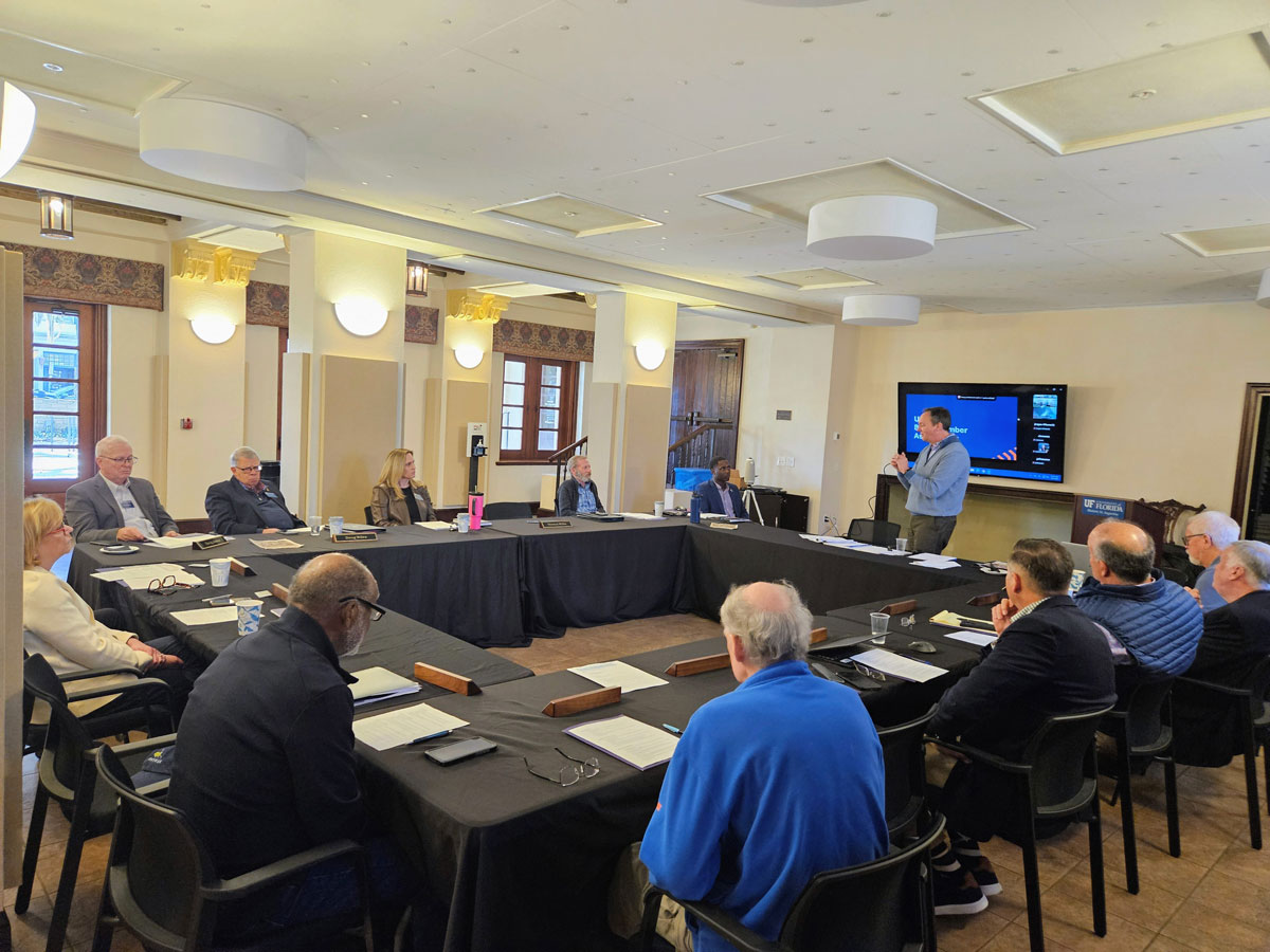 Board members sitting around square table during regular meeting